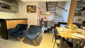 a dining room with a table and chairs and stairs at 407-3 · Duplex Sossego in Anápolis +40 photos