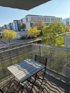 a table and chairs on the balcony of a building at Villeurbanne la soie - Rhône express in Villeurbanne +12 photos