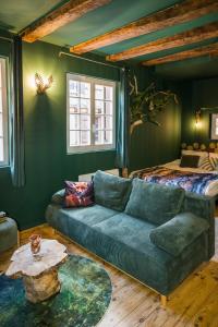 una sala de estar con un sofá y una cama en Le Sous-Bois, une parenthèse nature, en Bergerac