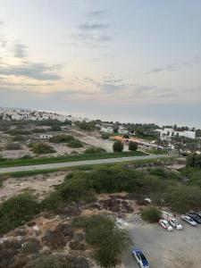 an aerial view of cars parked in a parking lot at Central Bliss Apartment in Muscat