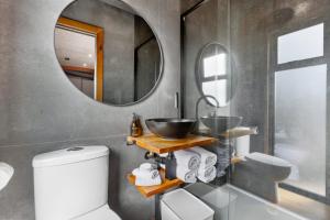 a bathroom with a sink and a mirror at Luxury Container and Cabin with Outdoor Bath in Wanaka
