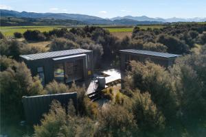 an aerial view of a house in a field at Luxury Container and Cabin with Outdoor Bath in Wanaka