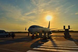 an airplane is sitting on the runway at sunset at Terminal Design Apartment - Terrasse & waipu TV, nahe Stuttgart Messe & Böblingen in Steinenbronn +16 photos