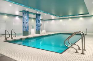 a swimming pool in a building with a blue ceiling at Executive Residency by Best Western Calgary City View North in Calgary