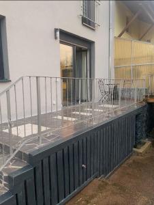 a balcony with a metal railing next to a building at Mira Suites 1 in Schwalbach