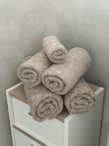 a pile of towels sitting on top of a white cabinet at Mira Suites 1 in Schwalbach