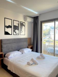 a bedroom with a large bed with two towels on it at appartement 3 chambres à côté de stade in Tangier
