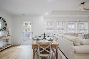 a living room with a couch and a table at Lowcountry Landing! 3-story Townhouse in Old Town's Promenade in Bluffton
