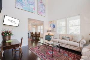 a living room with a couch and a table at Mary Margaret Cottage - Spacious 4 Bed Coastal Home, Historic Old Town Bluffton in Bluffton