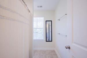 a white bathroom with a mirror and a shower at Mary Margaret Cottage - Spacious 4 Bed Coastal Home, Historic Old Town Bluffton in Bluffton +37 photos