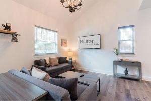 a living room with a couch and a table at Charming Old Town Loft, nestled in the Heart of Historic Bluffton, SC in Bluffton