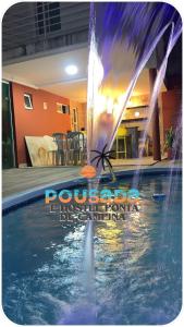a water fountain in the middle of a swimming pool at Pousada e Hostel Ponta de Campina in Cabedelo