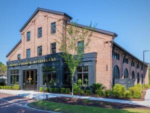 a brick building with a sign on the front of it at Charming Old Town Loft, nestled in the Heart of Historic Bluffton, SC in Bluffton