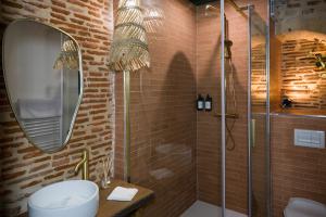 Un baño con ducha, lavabo y espejo. en Le Sous-Bois, une parenthèse nature, en Bergerac