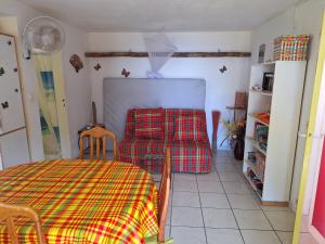 a room with a table and a bed in it at Gite DANGIEN in Vieux-Habitants