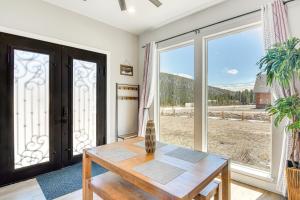 a room with a table and a large window at Romantic Mountain Retreat with Scenic Views! in Idaho Springs