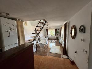 a kitchen and living room with a staircase in a house at Casa Alex in Hunedoara