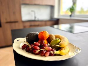 a plate of fruit sitting on a table at New flat close to center in Komárov