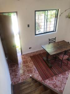 a room with a wooden table and a door at Chalet Bordemar in Concón
