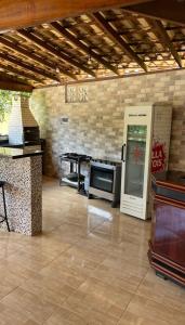 a kitchen with a table and a soda machine at Casa - Guarapari in Guarapari