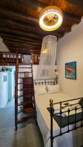 a bedroom with a bunk bed and a chandelier at eleni's cozy appartment in Kastron