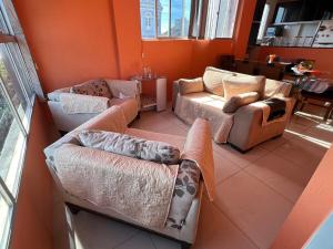 a living room with two couches and a couch at Lindo Nascer do Sol in Recife