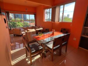 a dining room with a glass table and chairs at Lindo Nascer do Sol in Recife