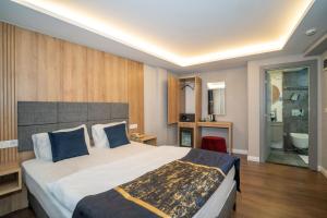 a hotel room with a large bed and a bathroom at Hotel Martini in Istanbul
