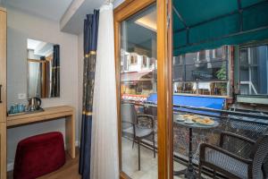a room with a balcony with a table and chairs at Hotel Martini in Istanbul +40 photos