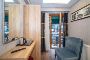 a room with a desk and a chair and a mirror at Hotel Martini in Istanbul