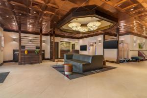a large lobby with a couch and a table at Best Western Plus Waltham Boston in Waltham