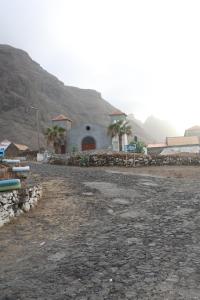 a building with palm trees in front of a mountain at The edge of the Atlantic 