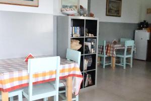 a dining room with a table and chairs and a book shelf at The edge of the Atlantic 