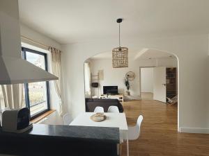 a living room with a white table and a couch at Quimper: T3 avec vue cathédrale proche gare in Quimper