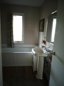 a bathroom with a sink and a bath tub at Biking, Hiking, Getaways & Relaxation Retreats - Visit the VT Chocolate Room - Large & Cozy, Homey, Jacuzzi Tub, Scenic Walks in Colchester