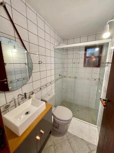 a bathroom with a sink and a toilet and a shower at Casa Arborizada - Bairro João Paulo Norte da ilha in Florianópolis +52 photos
