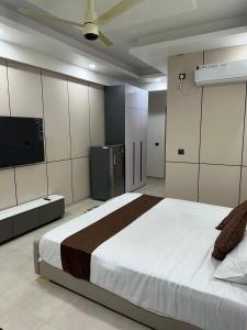 a bedroom with a large bed and a tv at Regal StayThe Perfect Blend of Luxury And Comfort in Nilmatha