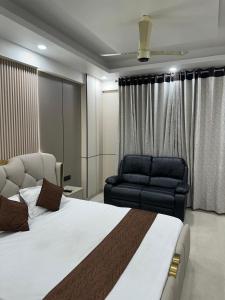 a bedroom with a large bed and a couch at Regal StayThe Perfect Blend of Luxury And Comfort in Nilmatha