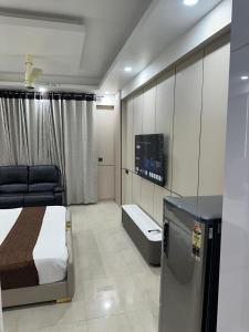 a bedroom with a bed and a tv in it at Regal StayThe Perfect Blend of Luxury And Comfort in Nilmatha
