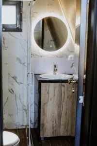 a bathroom with a sink and a mirror at A frame pool house in Ledinci