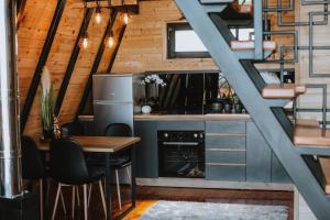 a kitchen with a table and a refrigerator at A frame pool house in Ledinci