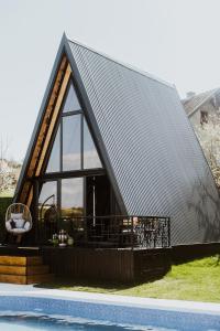 a large metal roofed house with a pool at A frame pool house in Ledinci