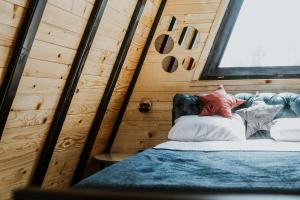 a bedroom with a bed in a wooden wall at A frame pool house in Ledinci +38 photos