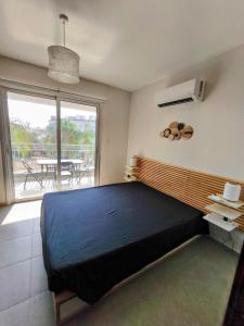 Ένα ή περισσότερα κρεβάτια σε δωμάτιο στο Harmonia Home