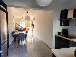 a kitchen and dining room with a table and chairs at Harmonia Home in Paralimni