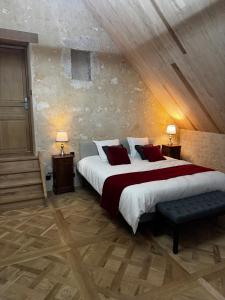 a bedroom with a large bed and two lamps at Le Relai Valdieu in Courgeon +22 photos