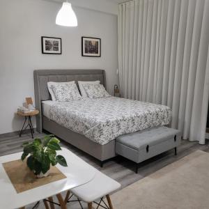 ein Schlafzimmer mit einem Bett, einem Tisch und einer Pflanze in der Unterkunft Bolhão Skyline in Porto