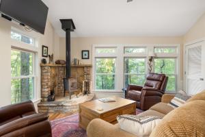 a living room with a couch and a fireplace at Private Cozy Lake Escape in Lula