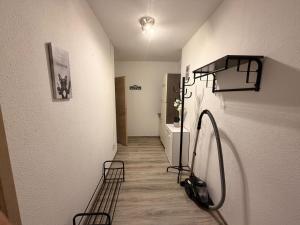 a room with a hallway with chairs and a refrigerator at Apartment DENISA in Gera