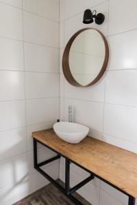 a bathroom with a white sink and a mirror at Hof Driewegen in Driewegen +36 photos